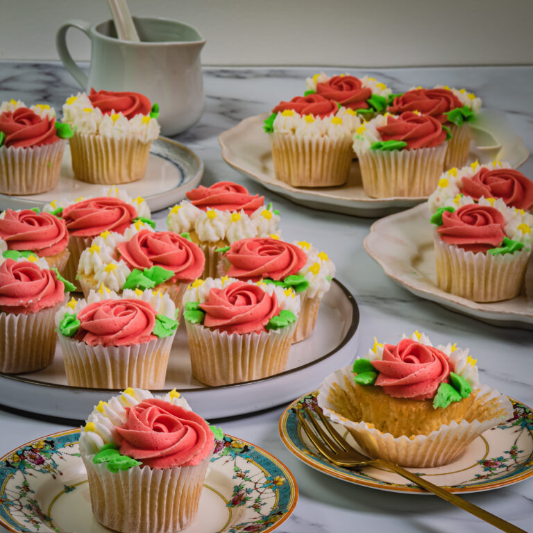 A collection of different coloured and flavored cupcakes